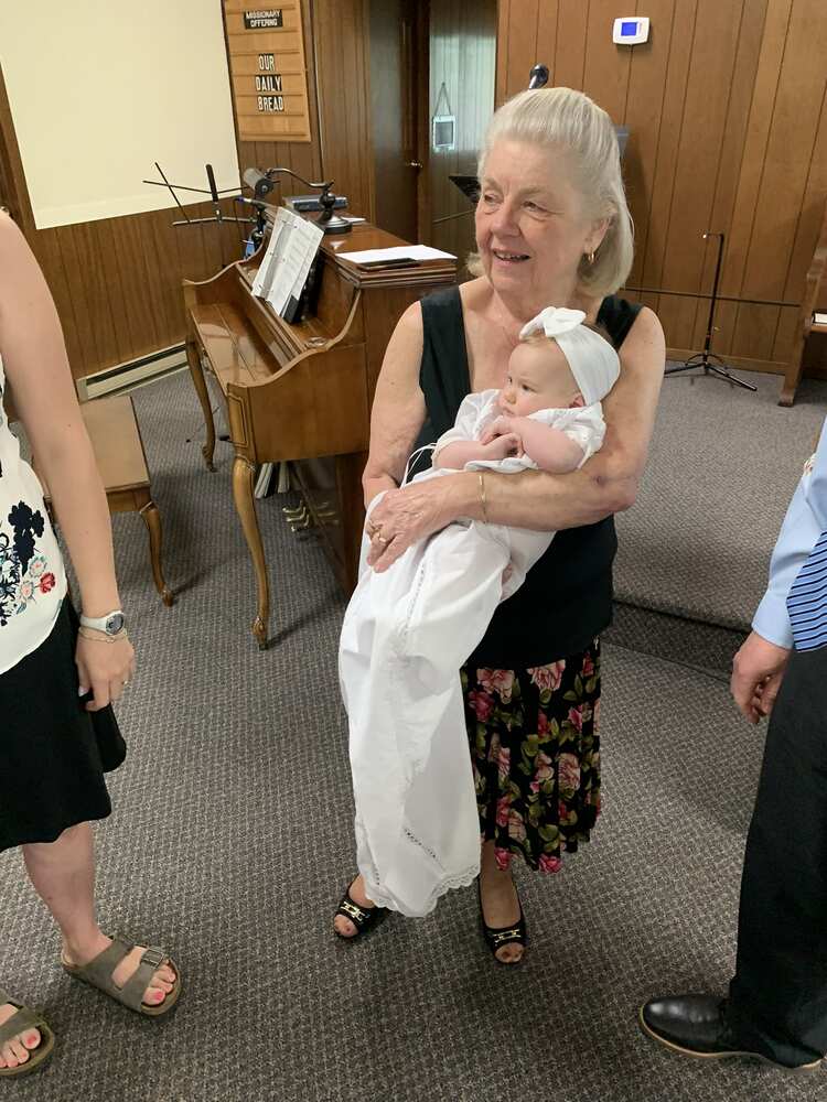 Grandmother smiling down at the baby in the sanctuary
