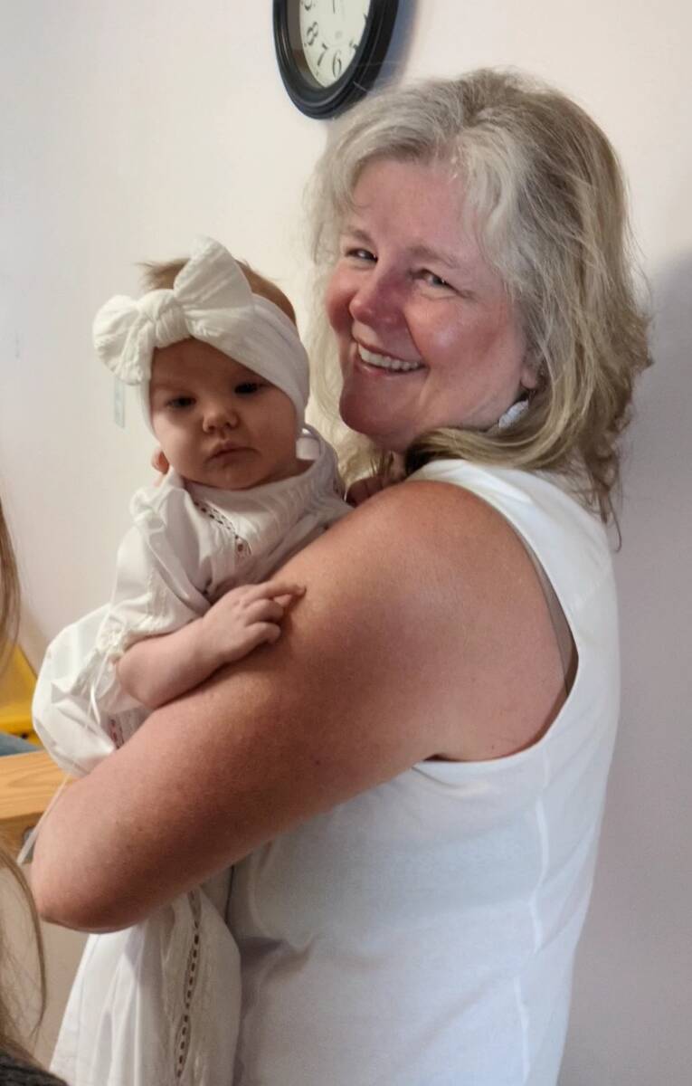 Woman smiling with the baby on her shoulder