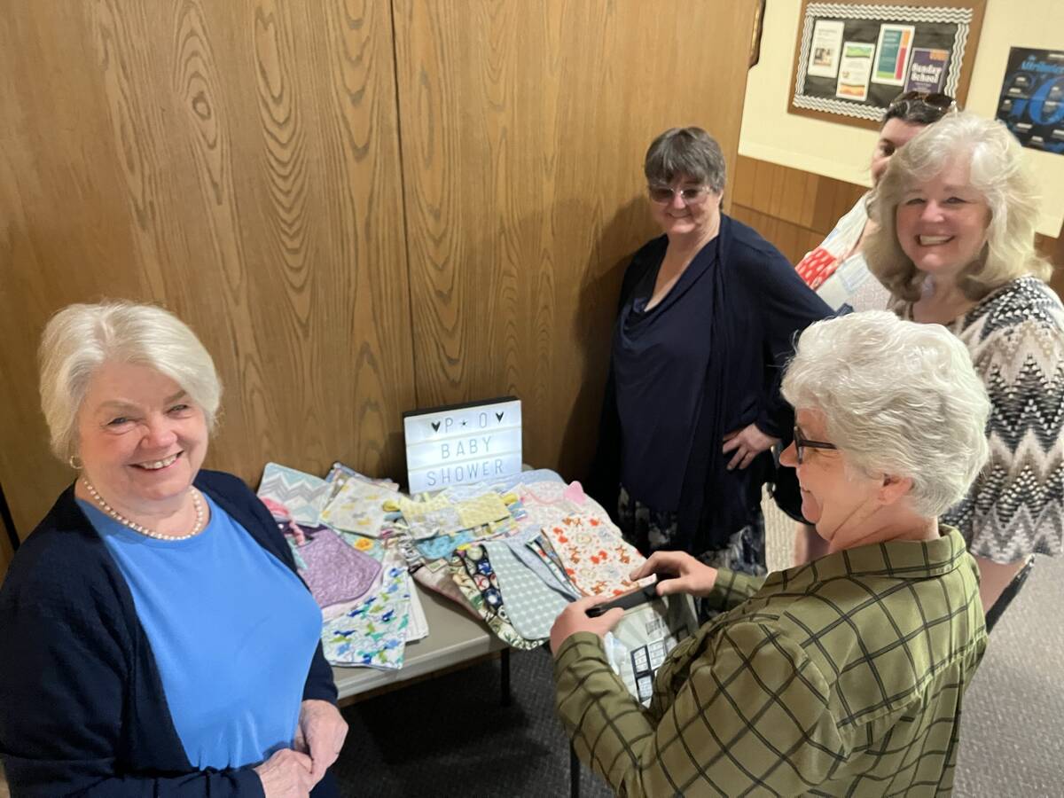 Women smiling while opening handmade gifts