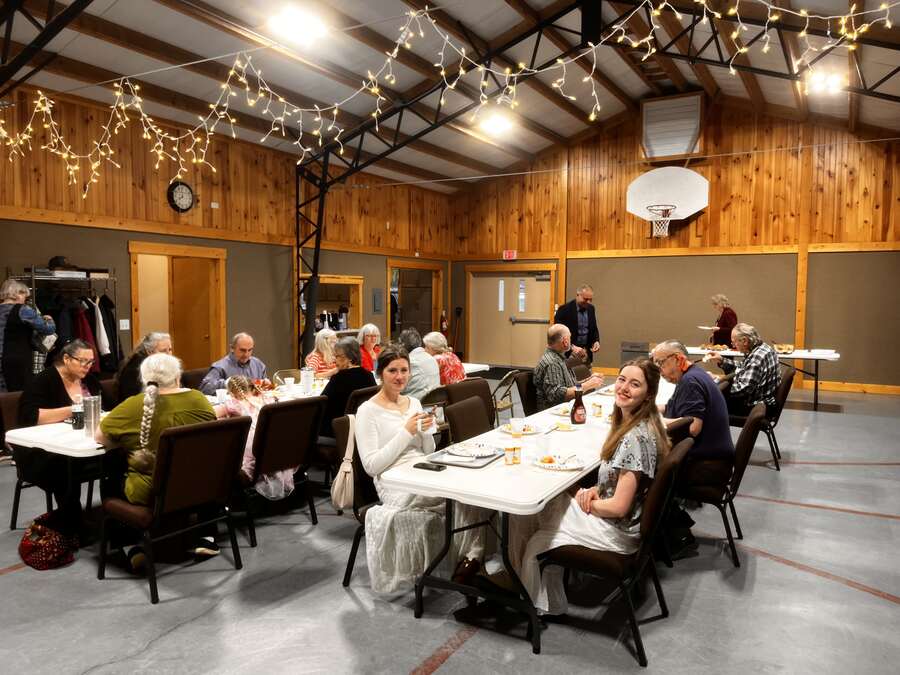 Fellowship hall glowing with string lights during an evening gathering