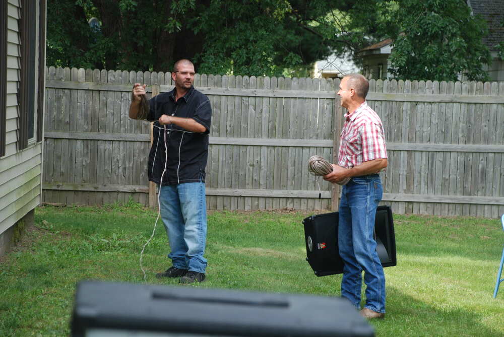 Two men talking on the lawn before the outdoor service